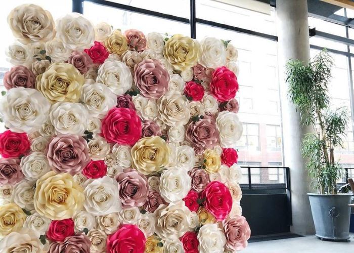 What are some tips for making and arranging paper flower wall decor?