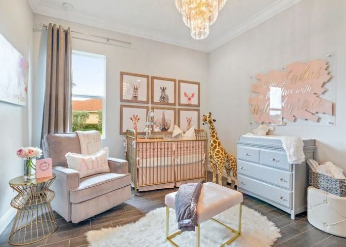 What are some essential decor items for a baby girl's nursery?